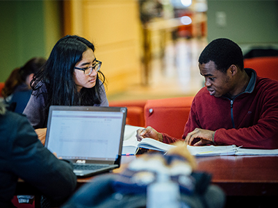 Two students study at a table