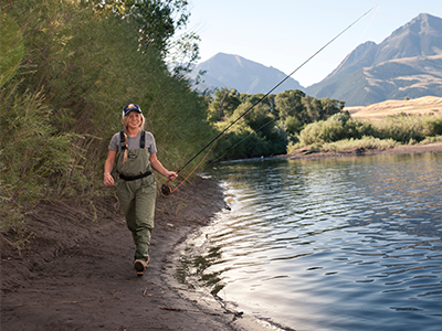 A student fishes along the river.