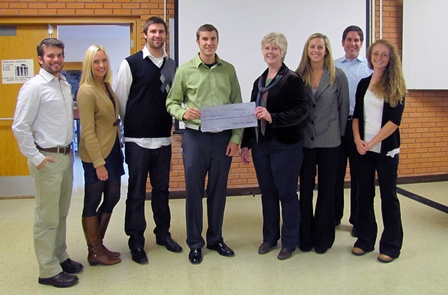 Students present a check to a person from Eagle Mount