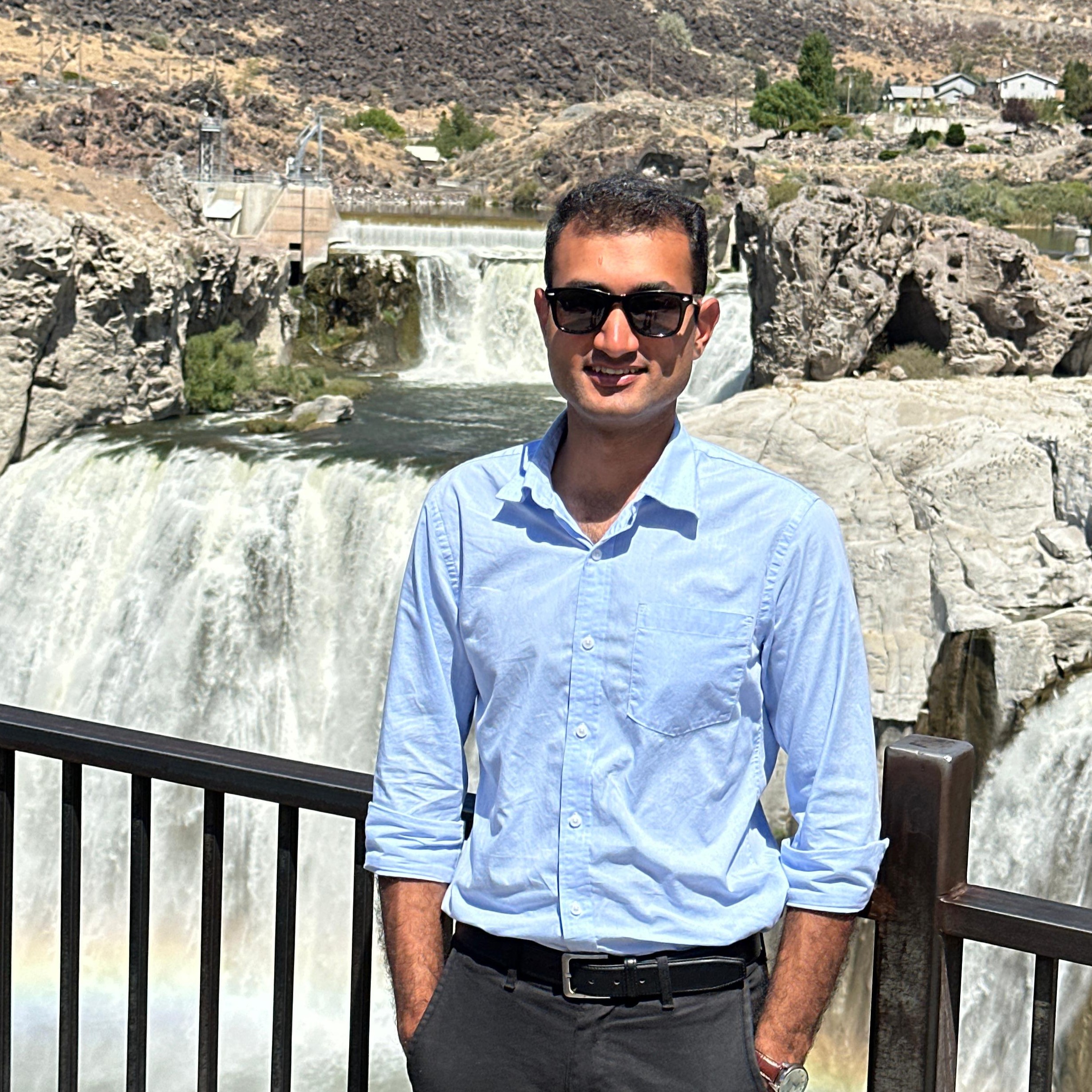 Haider outside in front of a waterfall