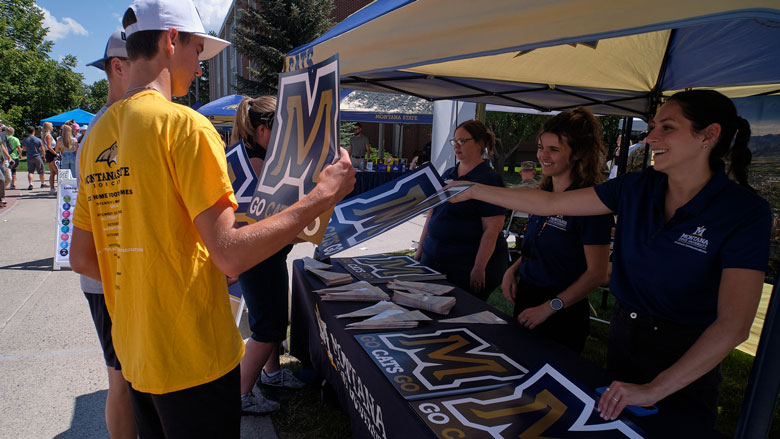 MSU employees handing out swag for Catapalooza