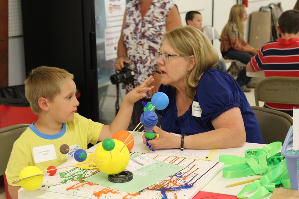 A boy presents his science project.