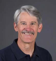 Headshot of David Atkins in a dark blue polo.