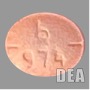 A lab image of an orange-ish red-ish pill