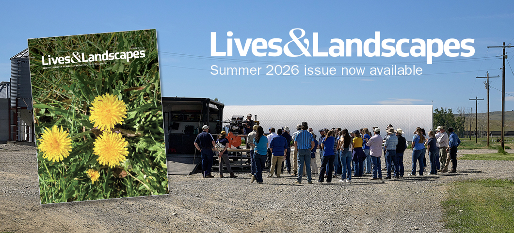 Promotional graphic for the Summer 2026 issue of Lives & Landscapes. The magazine cover featuring yellow dandelions is shown on the left. In the background, a group of people gathers outdoors near agricultural buildings and equipment.
