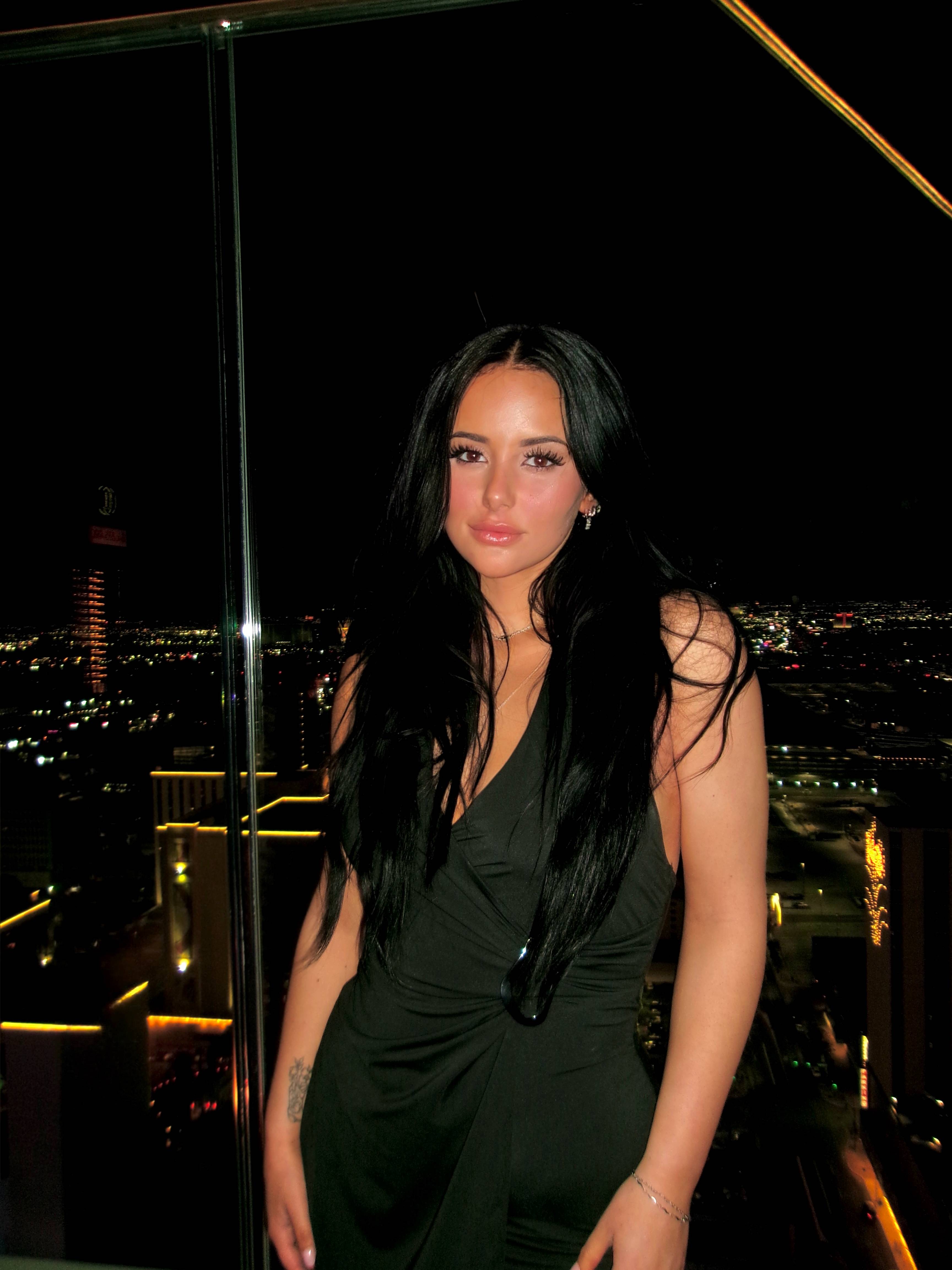 Female student wearing a black dress at night