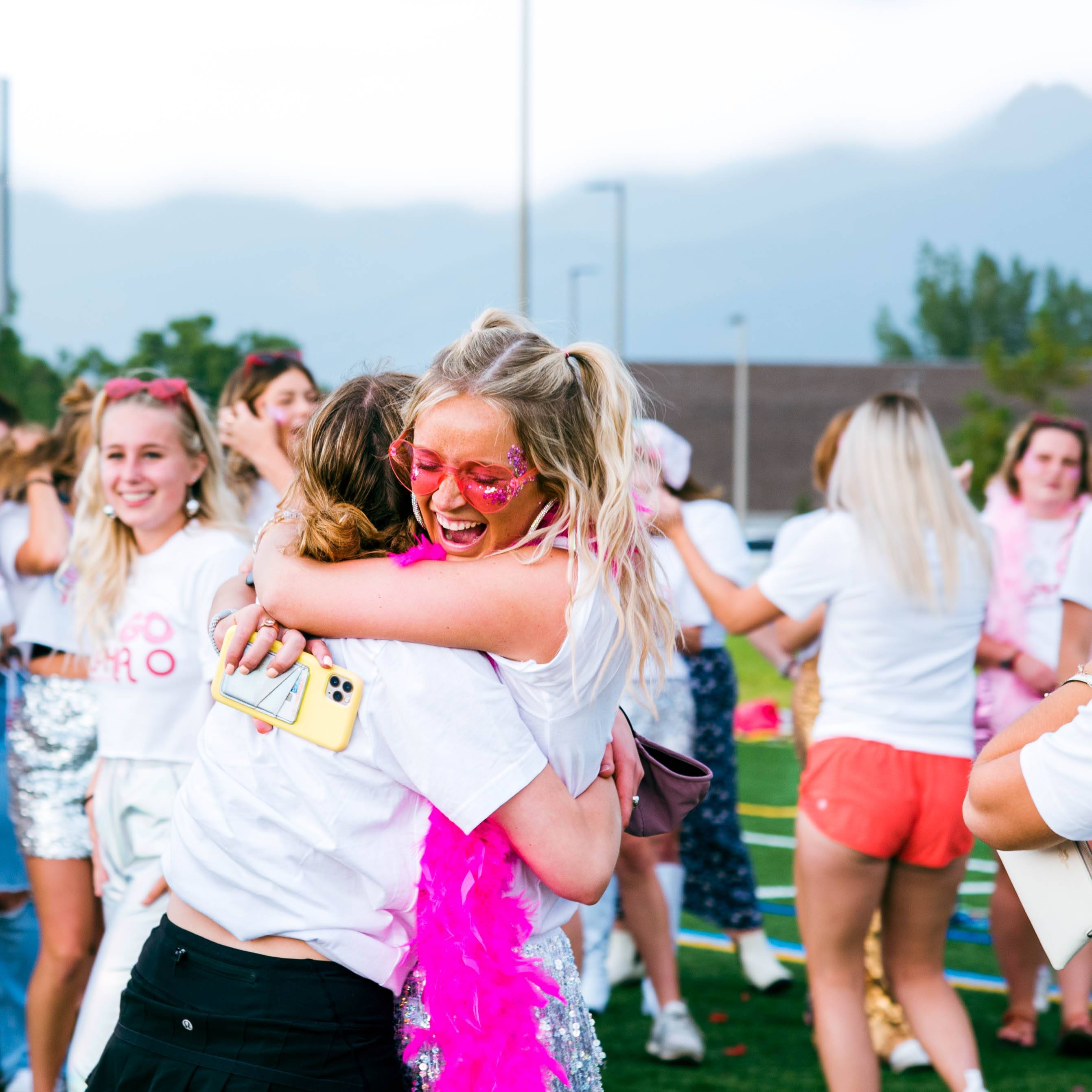 Happy students embracing their new sorority sisters