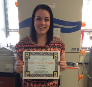 Student, AnneMarie Criddle, holding award